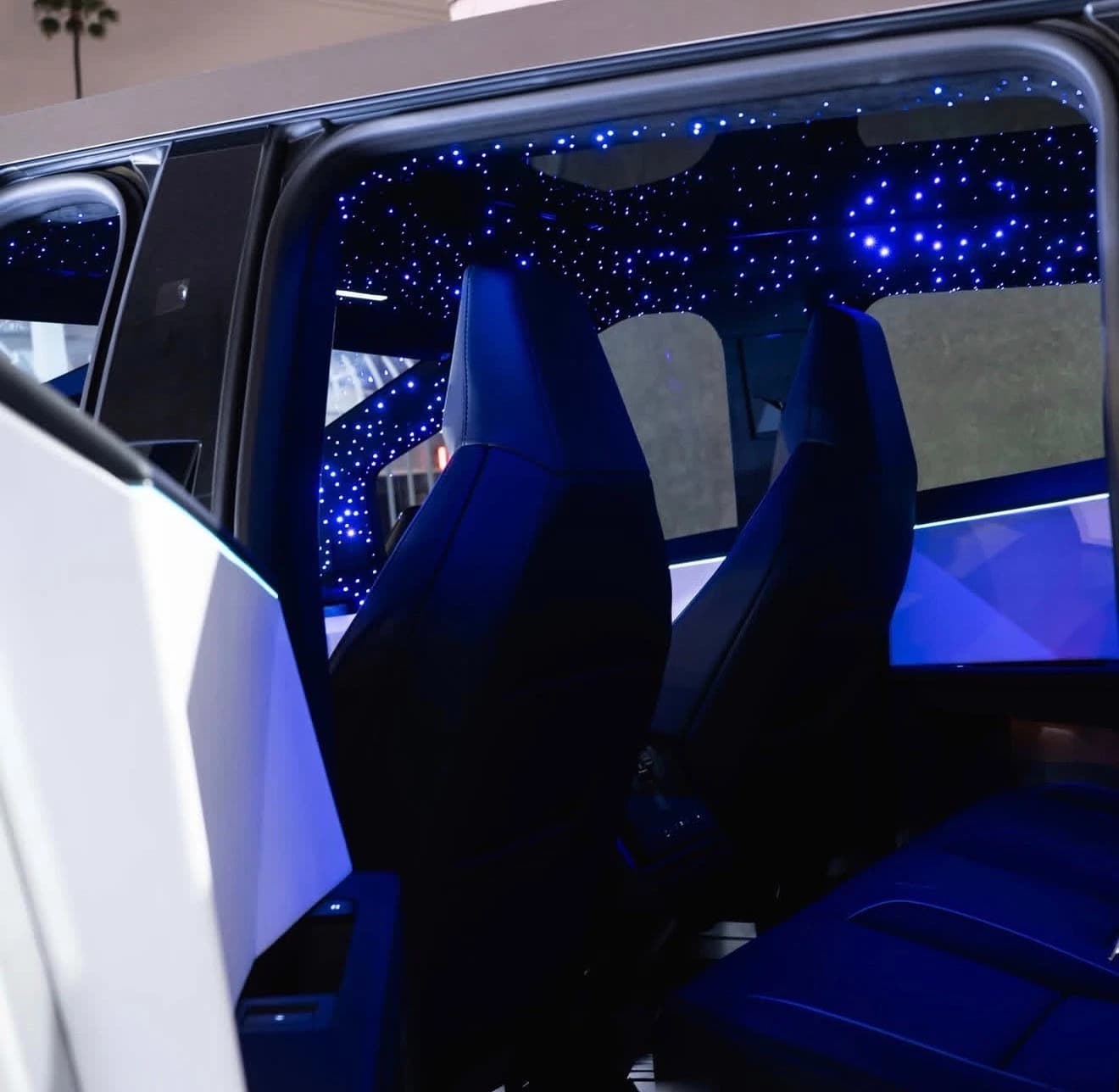 Custom Cybertruck cabin with blue lighting and a starlight roof
