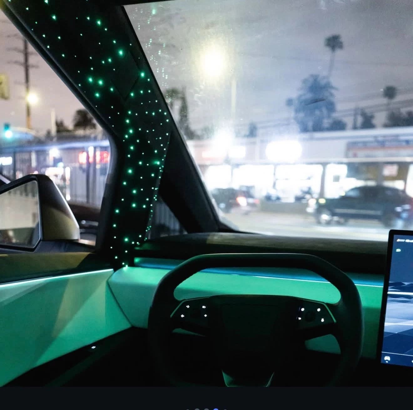 Green lighting around the Cybertruck dashboard and steering wheel