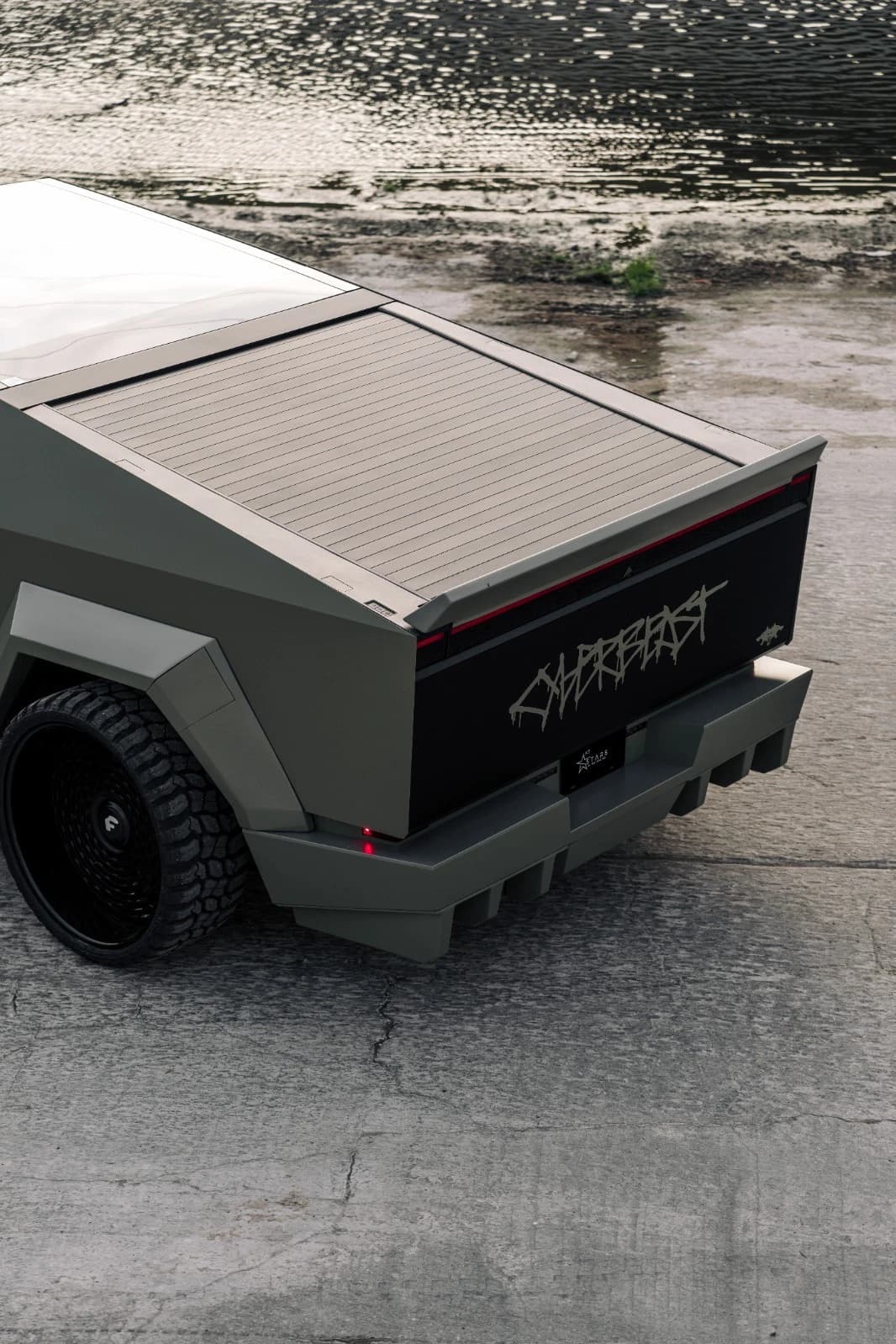 Rear view of the custom Cybertruck and its covered bed